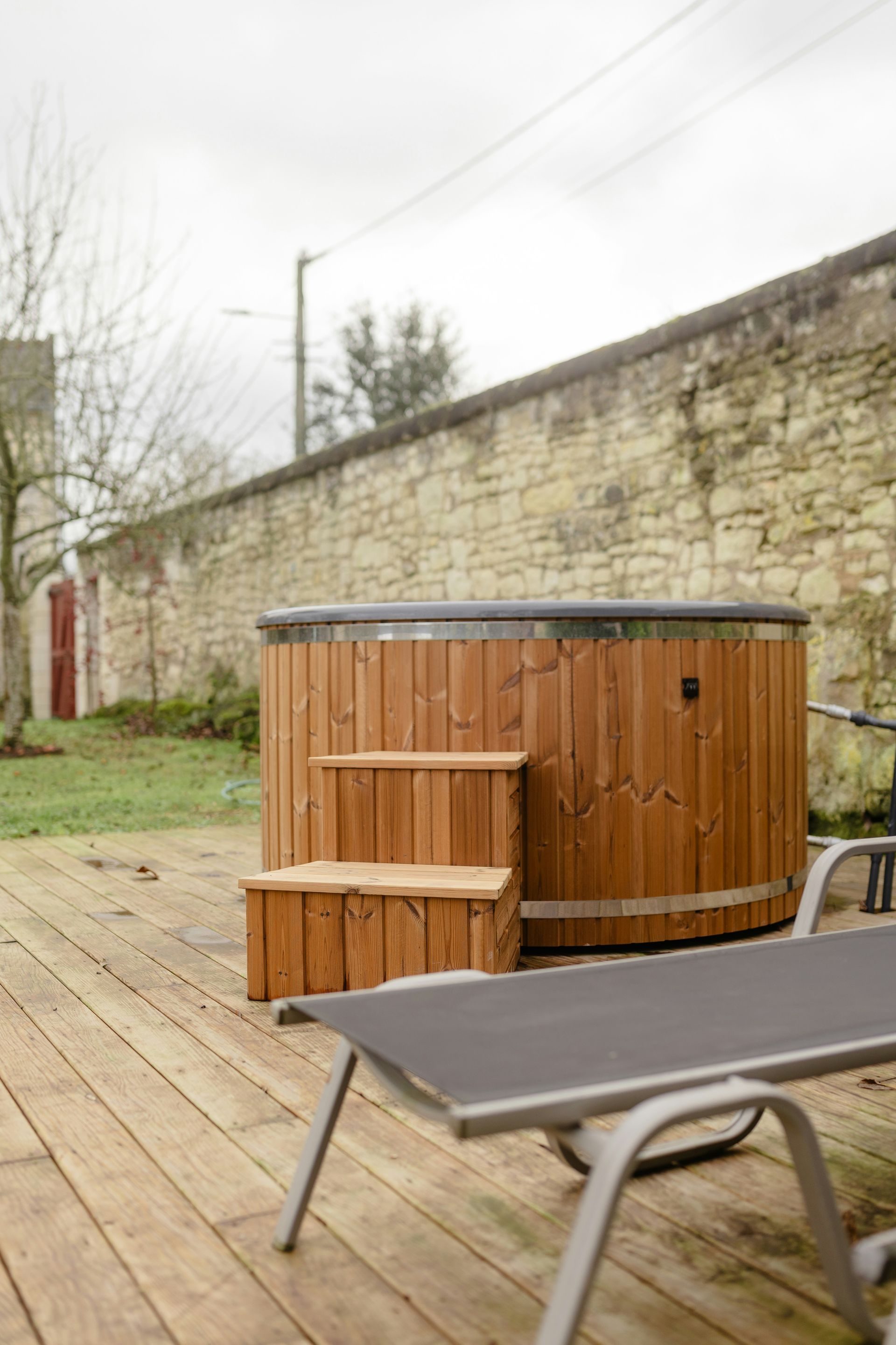 A hot tub sitting on top of a wooden deck